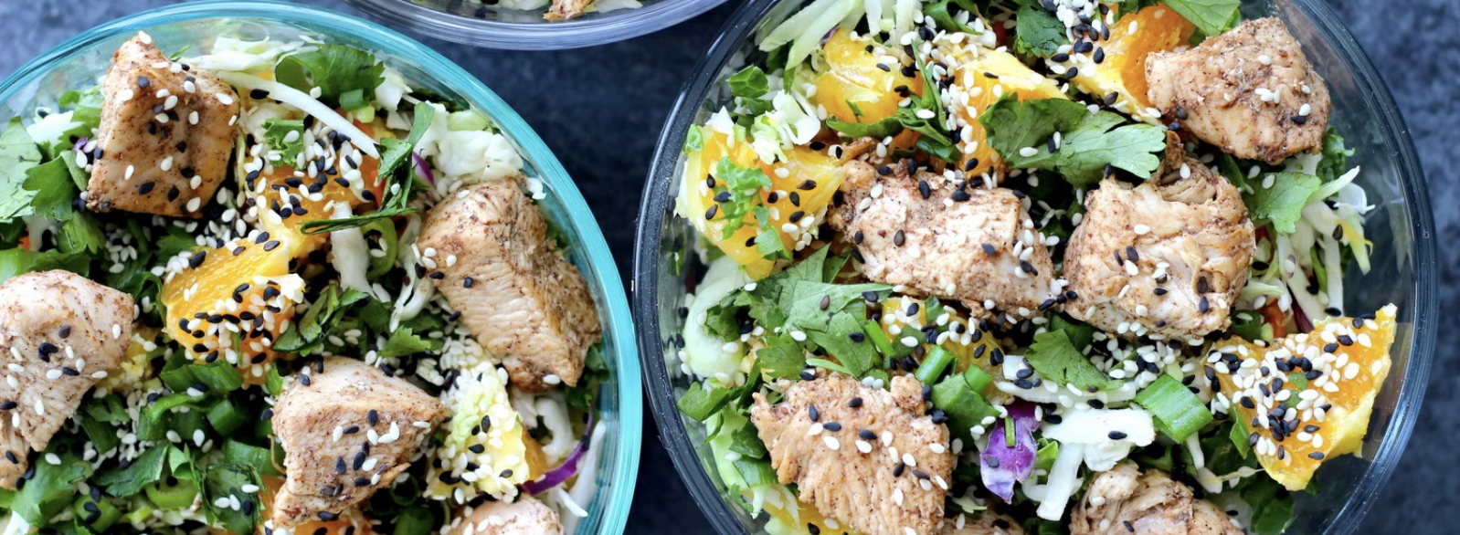 sesame chicken chopped salad with oranges, cilantro, and sesame seeds